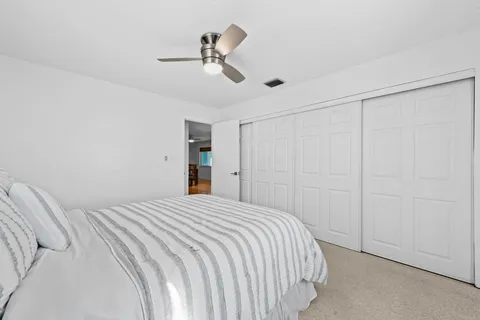a bedroom with a large bed and a chandelier