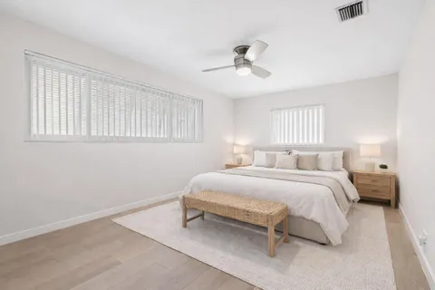 a spacious bedroom with a bed and a ceiling fan