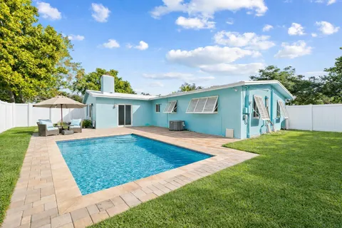a front view of house with yard and outdoor seating