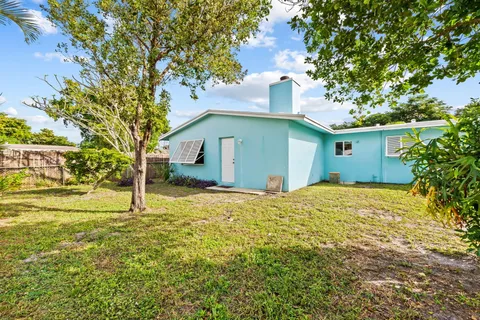 a house that has a tree in front of it