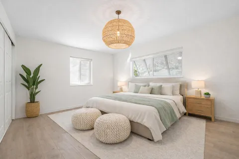 a bedroom with a bed and window