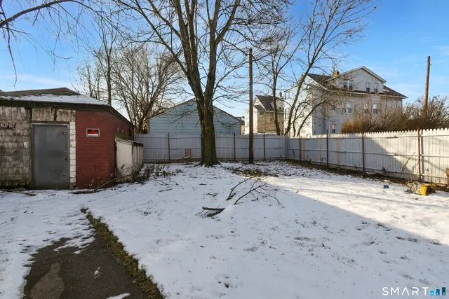 a front view of a building with a yard and garage