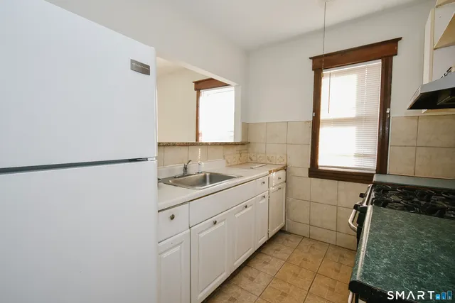 a kitchen with a sink and a refrigerator