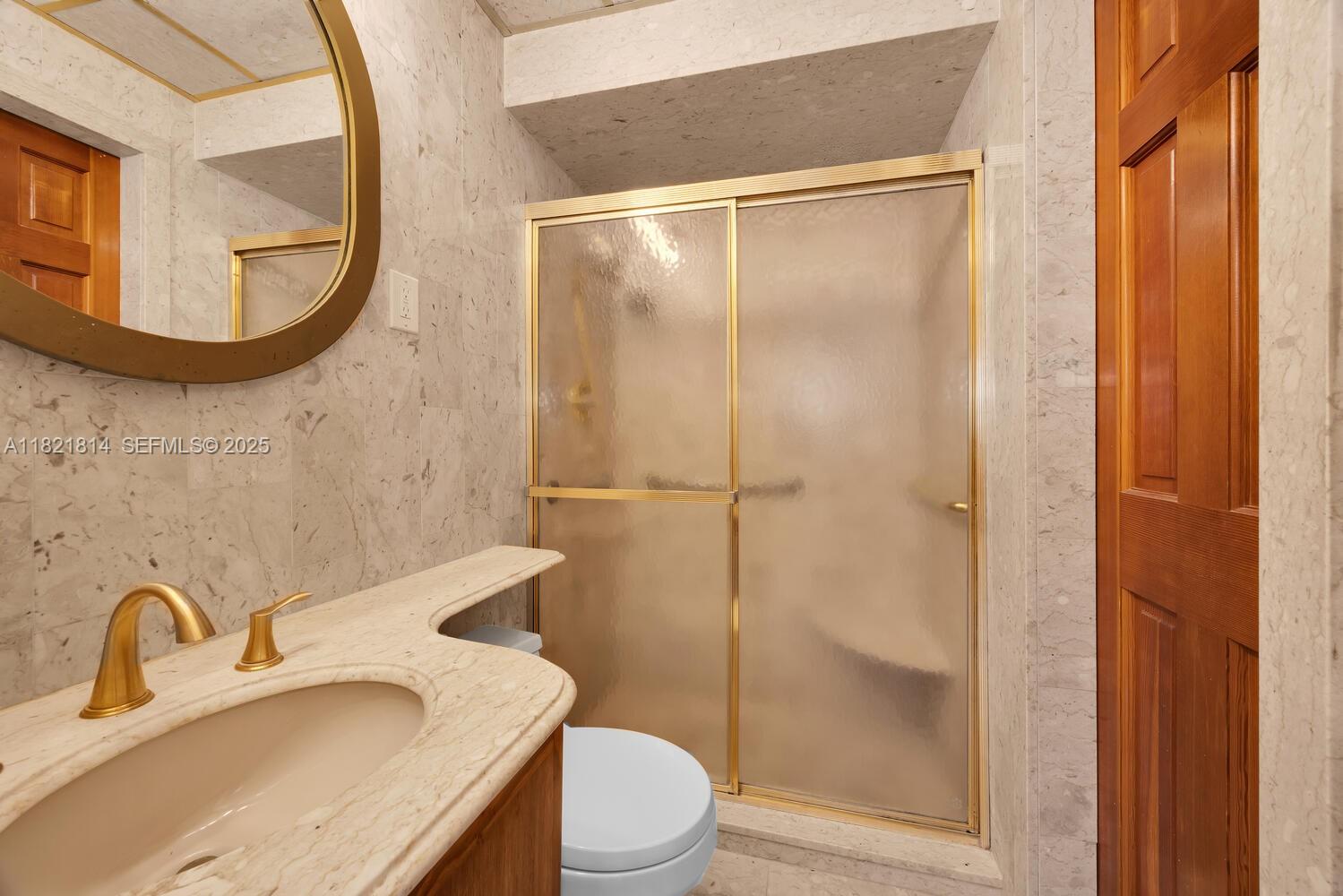 5025 Southwest 90th Court Miami, FL 33165 - Photo 9 of 18 a bathroom with a sink a toilet and a mirror