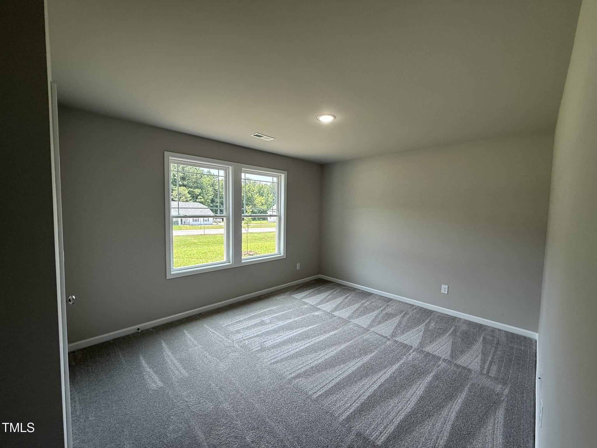 332 Magnolia Run Way Benson, NC 27504 - Photo 12 of 16 a view of an empty room and window