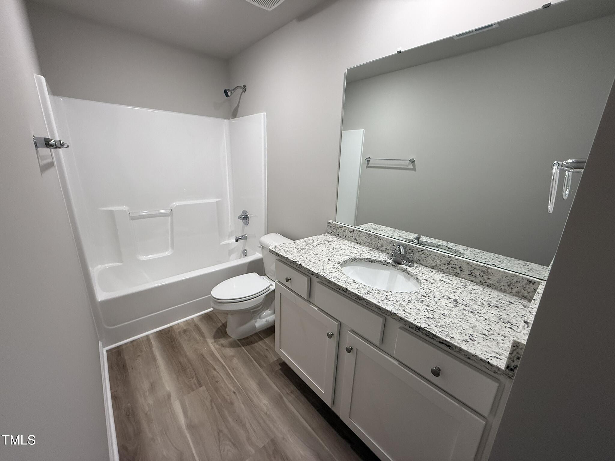332 Magnolia Run Way Benson, NC 27504 - Photo 14 of 16 a bathroom with a granite countertop sink toilet and shower