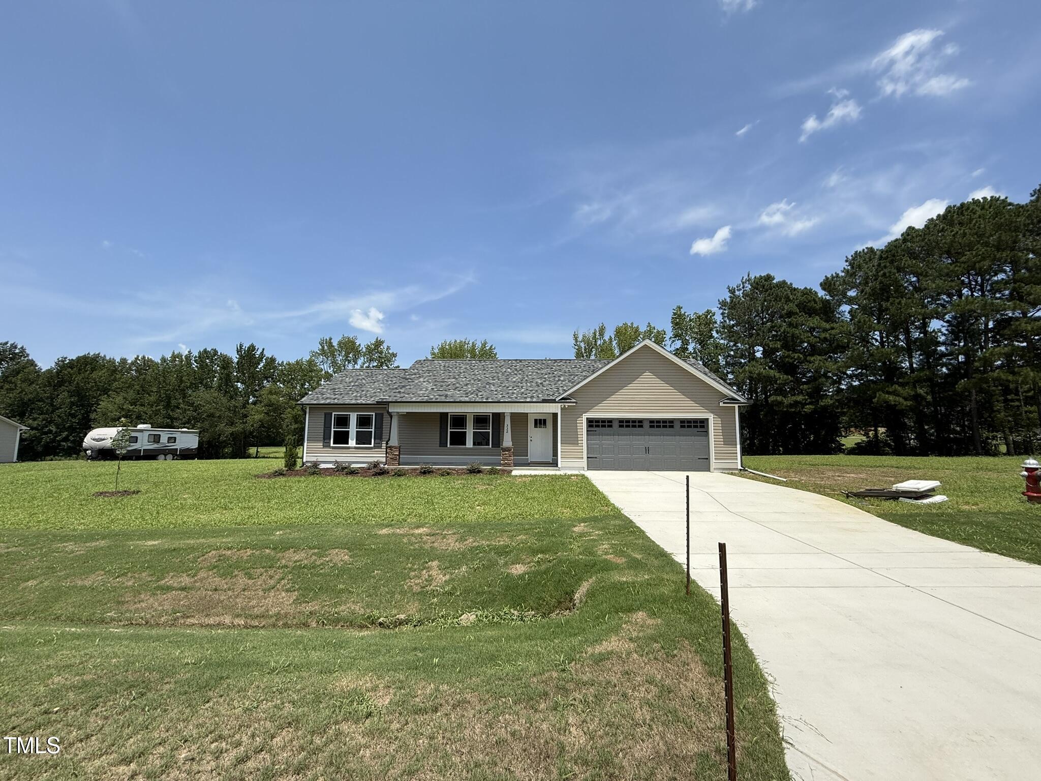 332 Magnolia Run Way Benson, NC 27504 - Photo 2 of 16 a front view of a house with a yard