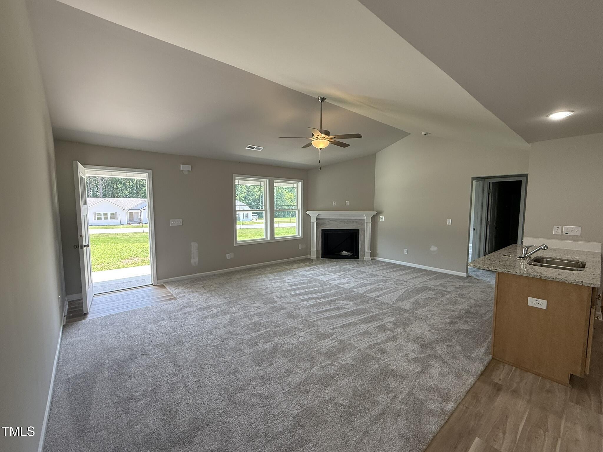 332 Magnolia Run Way Benson, NC 27504 - Photo 4 of 16 a view of an empty room with a window and a kitchen