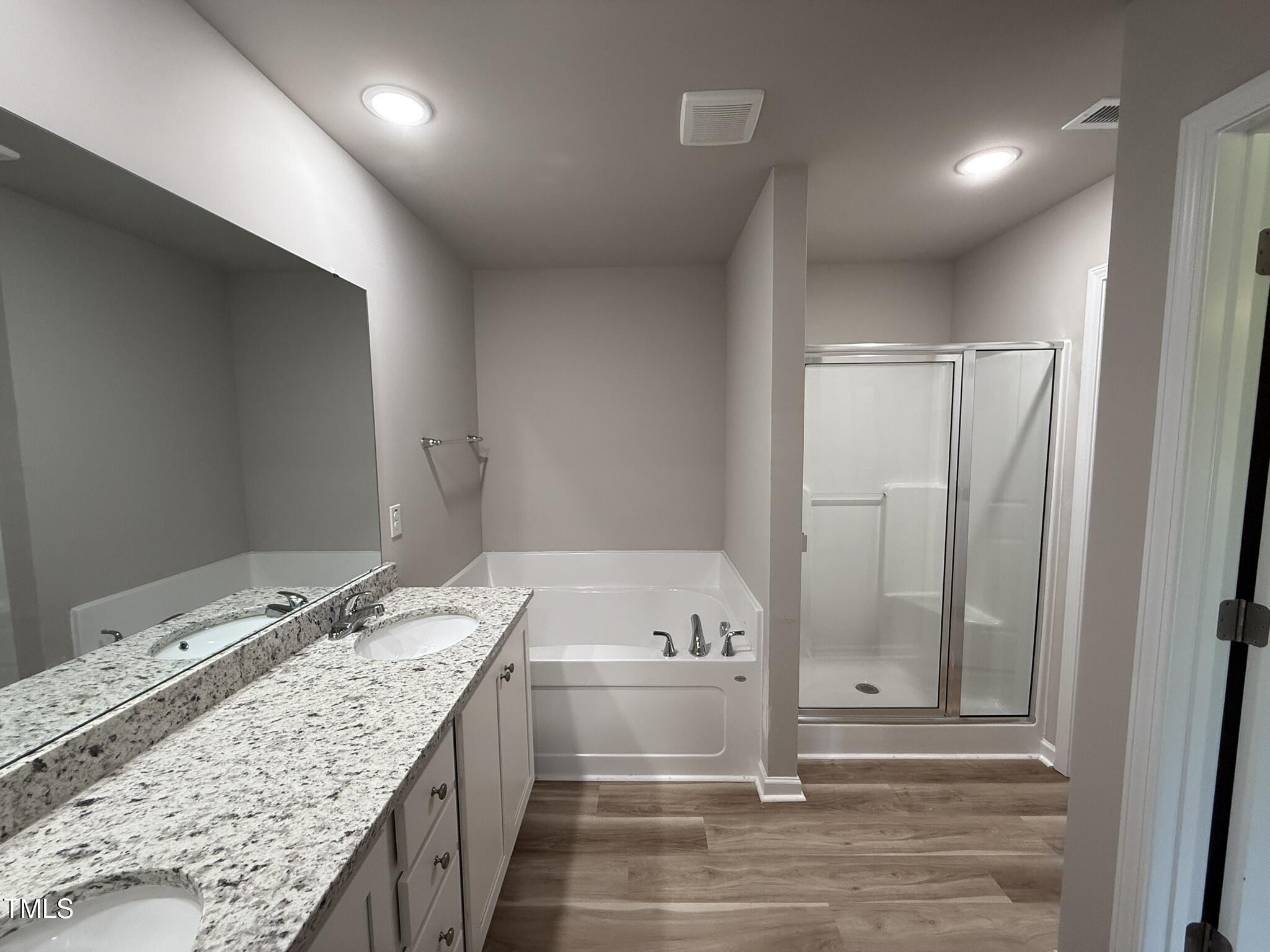 332 Magnolia Run Way Benson, NC 27504 - Photo 10 of 16 a bathroom with a granite countertop sink and a bathtub