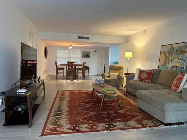 a living room with furniture and a rug
