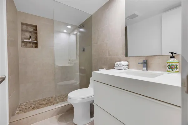 a bathroom with a sink toilet and shower