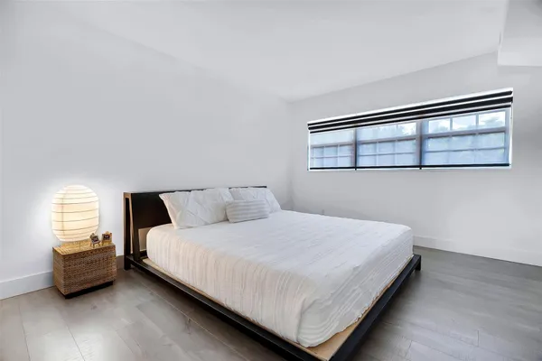 a bedroom with a bed and window