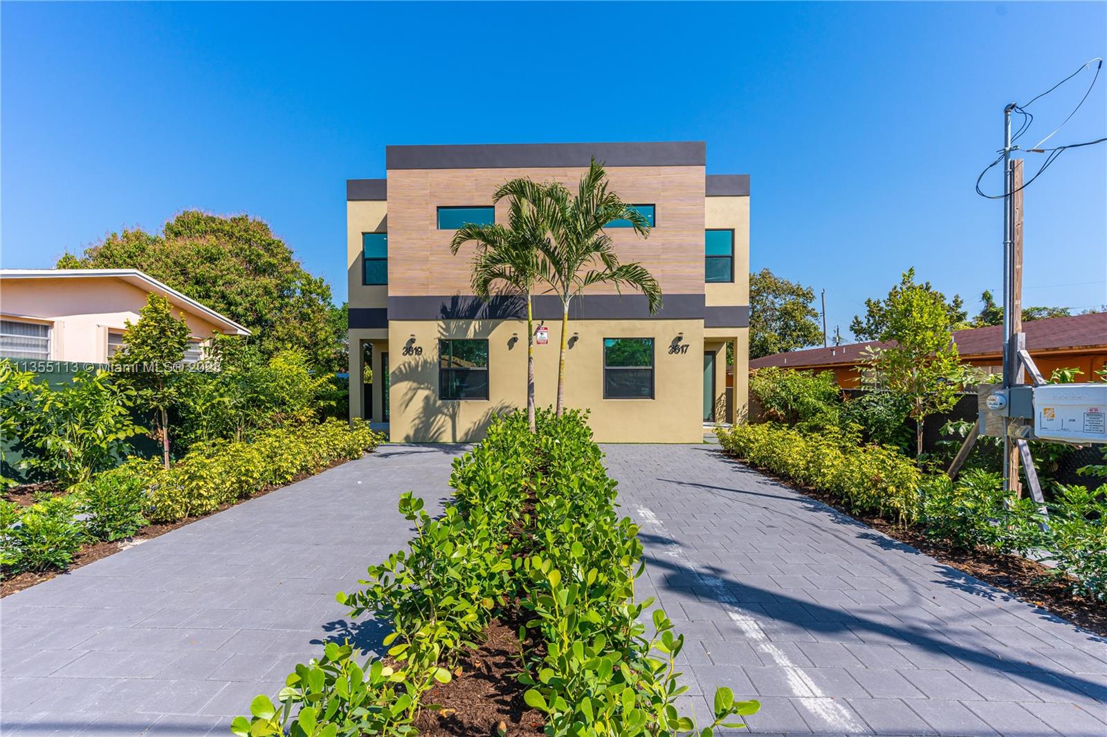 a front view of a house with a yard and outdoor seating