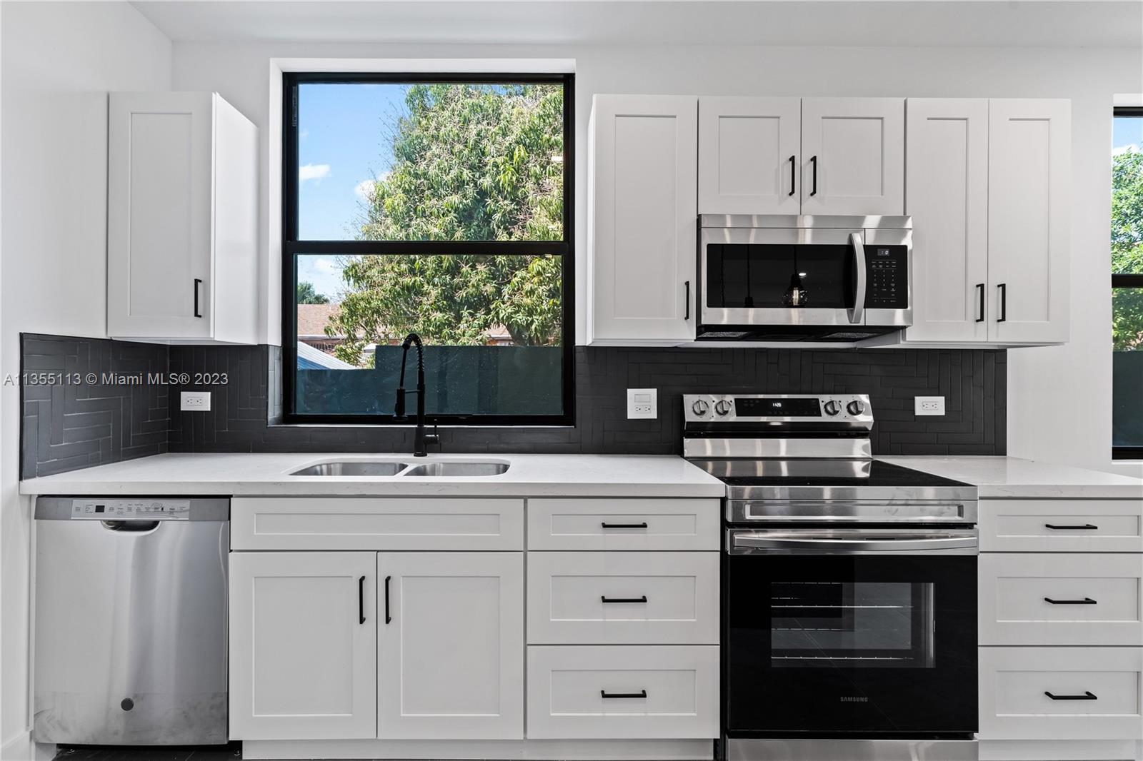 3617 Southwest 27th Street Miami, FL 33133 - Photo 12 of 29 a kitchen with white cabinets and appliances