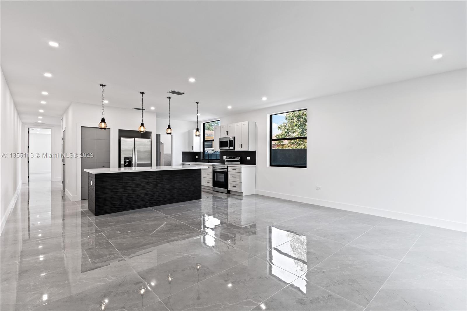 3617 Southwest 27th Street Miami, FL 33133 - Photo 16 of 29 a living room with stainless steel appliances kitchen island granite countertop furniture and a view of kitchen
