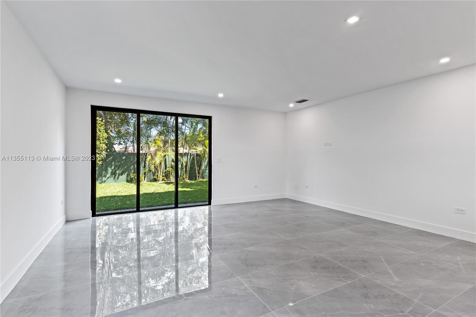 3617 Southwest 27th Street Miami, FL 33133 - Photo 17 of 29 a view of an empty room with wooden floor and a window