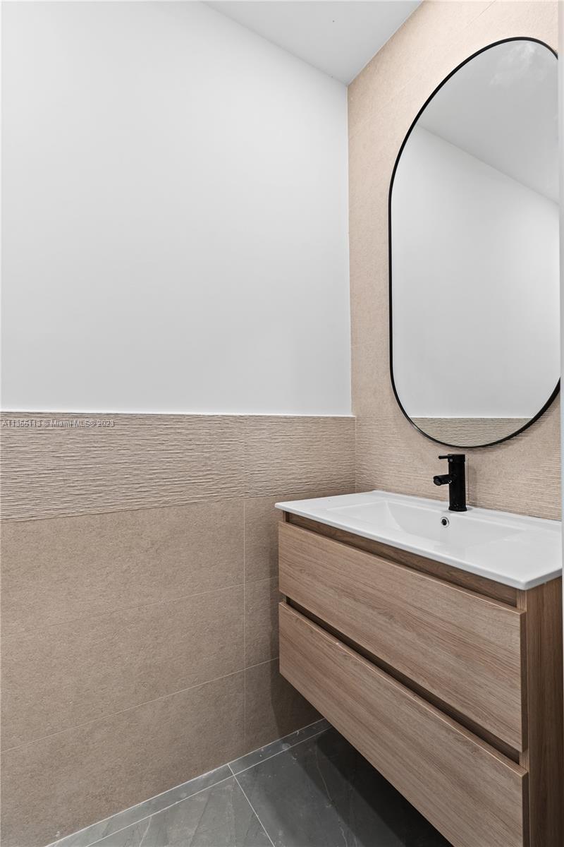 3617 Southwest 27th Street Miami, FL 33133 - Photo 19 of 29 a bathroom with a sink and a mirror