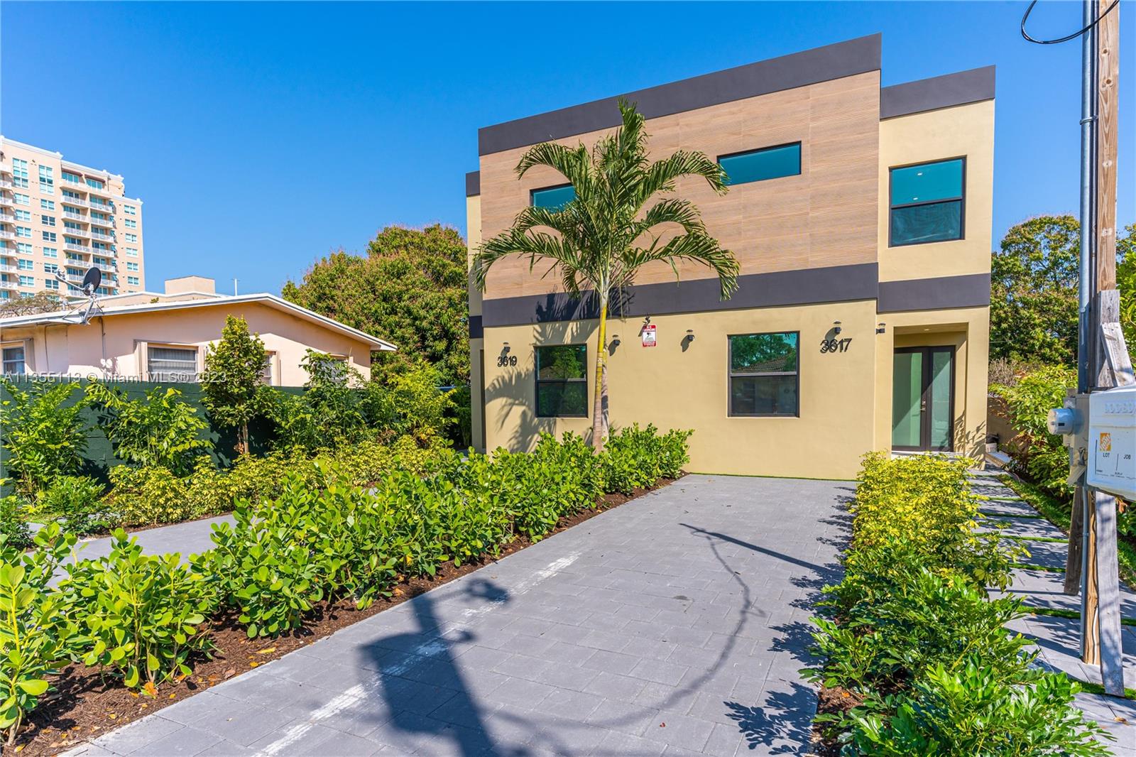 3617 Southwest 27th Street Miami, FL 33133 - Photo 2 of 29 a front view of a house with a yard and potted plants