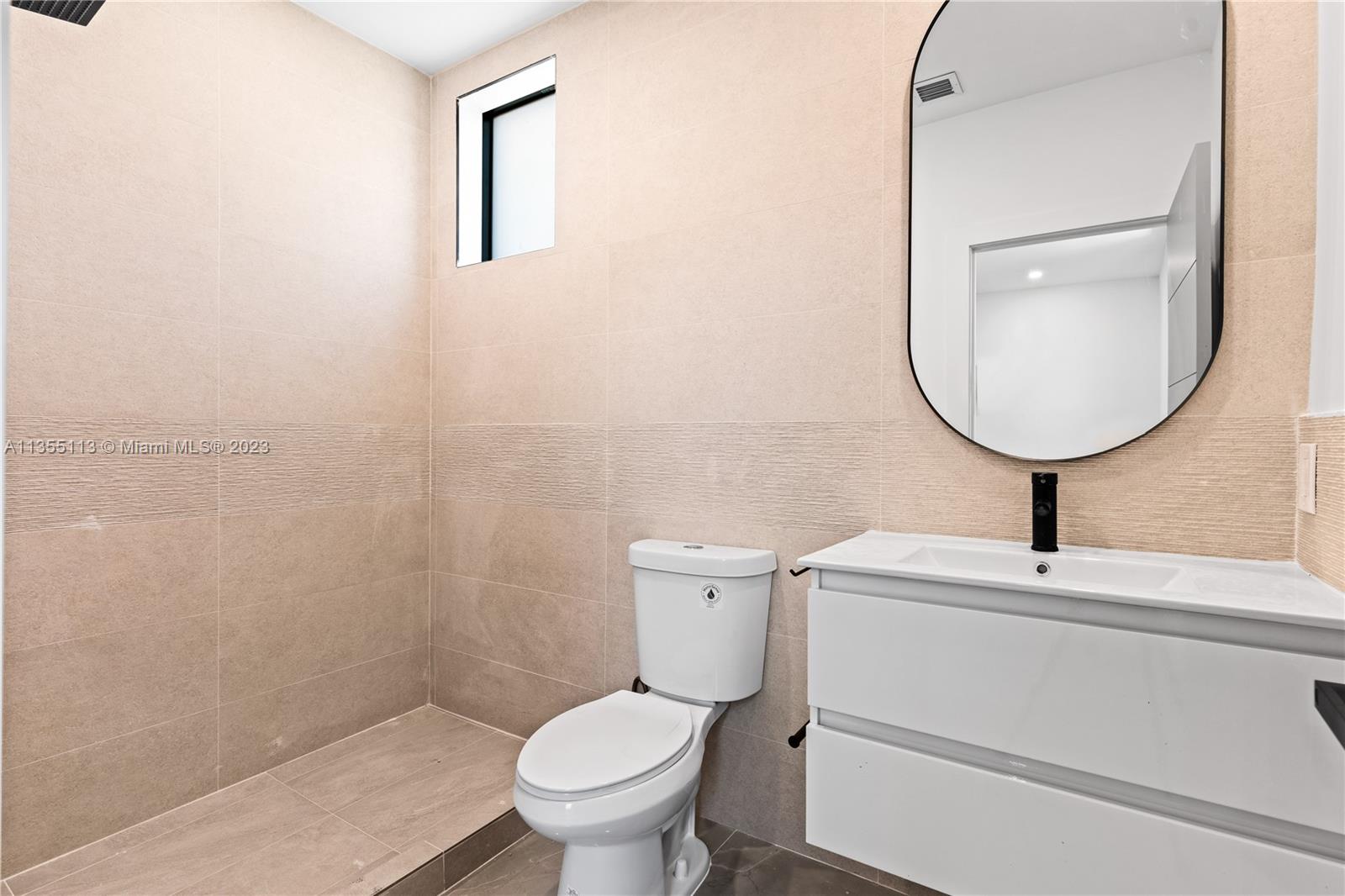 3617 Southwest 27th Street Miami, FL 33133 - Photo 26 of 29 a bathroom with a toilet sink and mirror