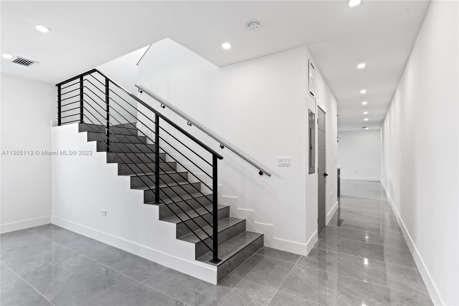 3617 Southwest 27th Street Miami, FL 33133 - Photo 9 of 29 a view of entryway with stairs and wooden floor