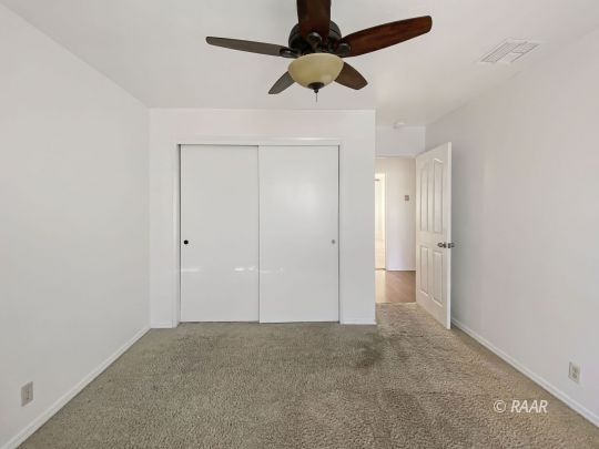332 North Fairview Street Ridgecrest, CA 93555 - Photo 6 of 16 an empty room with a ceiling fan and a window