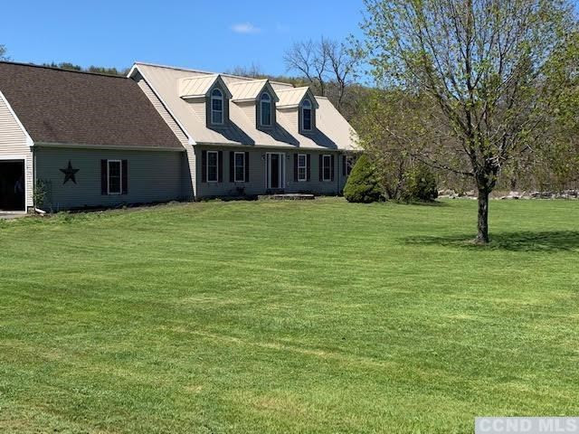 57 Waldorf Ridge Road Copake, NY 12516 - Photo 1 of 22 a front view of a house with a garden