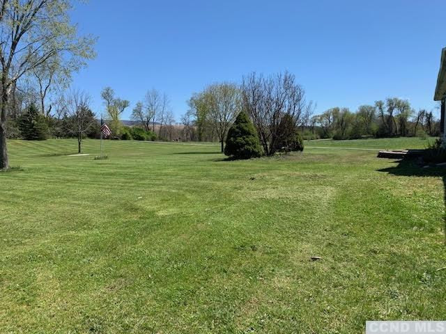 57 Waldorf Ridge Road Copake, NY 12516 - Photo 4 of 22 a view of field with trees in the background