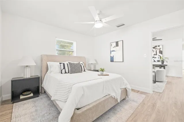 a bedroom with a bed and wooden floor