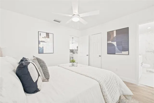 a bedroom with a bed and a painting on the wall
