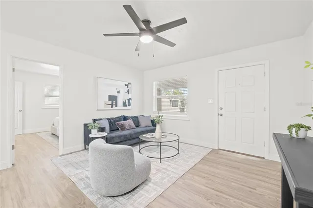 a living room with furniture and a wooden floor