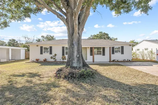 front view of a house with a large trees