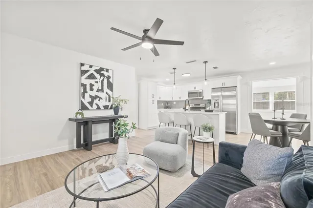 a living room with furniture and a wooden floor