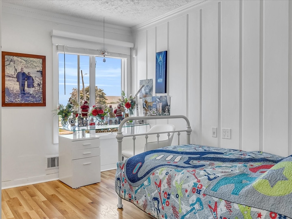 282 Atlantic Avenue Swampscott, MA 01907 - Photo 20 of 28 a bed sitting in a bedroom next to a window