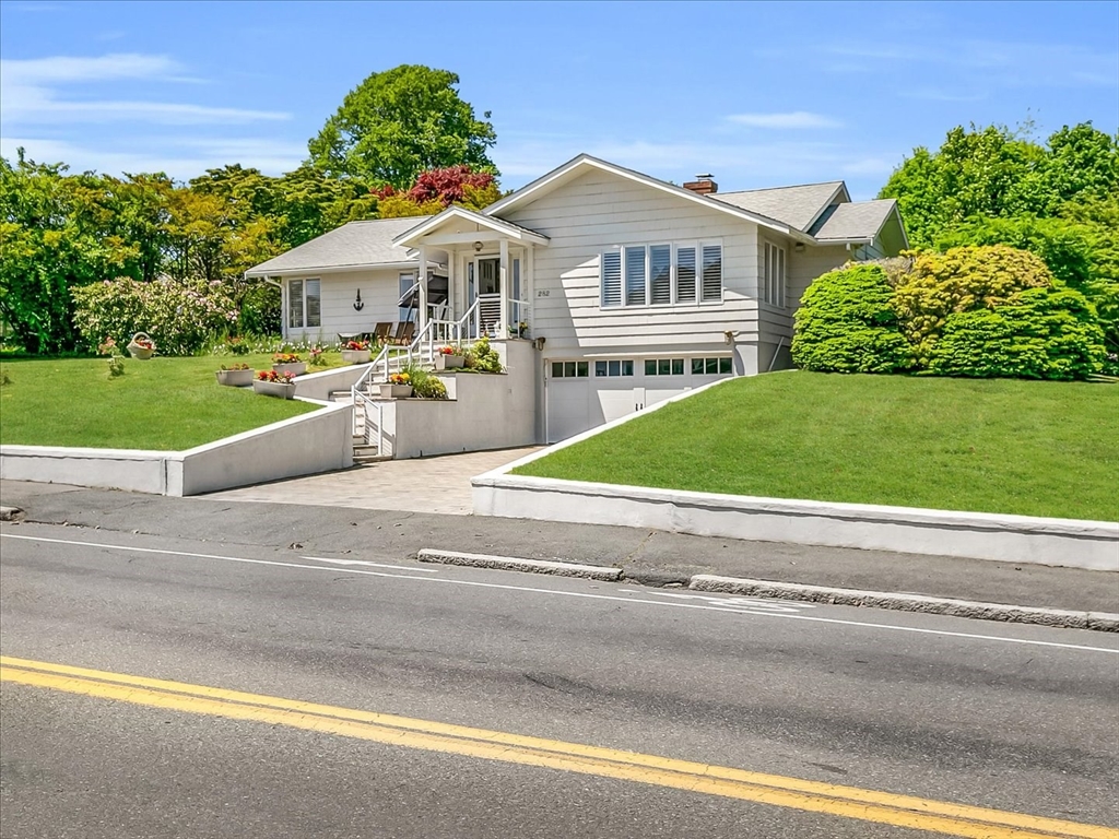 282 Atlantic Avenue Swampscott, MA 01907 - Photo 2 of 28 a front view of a house with a yard and potted plants