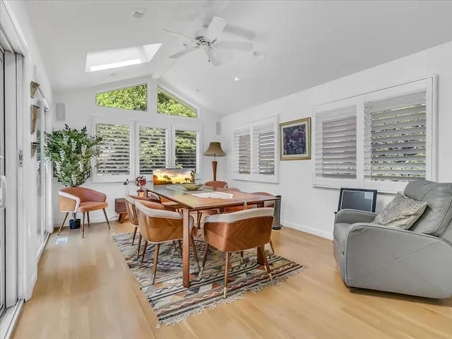 a view of a dining room with furniture window and wooden floor
