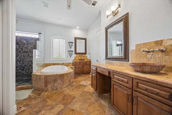 a spacious bathroom with a granite countertop sink a toilet a mirror and bathtub