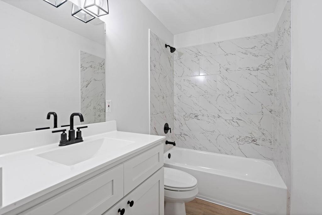 351 Edith Avenue Memphis, TN 38126 - Photo 15 of 15 Bathroom with shower / washtub combination, vanity, and wood finished floors