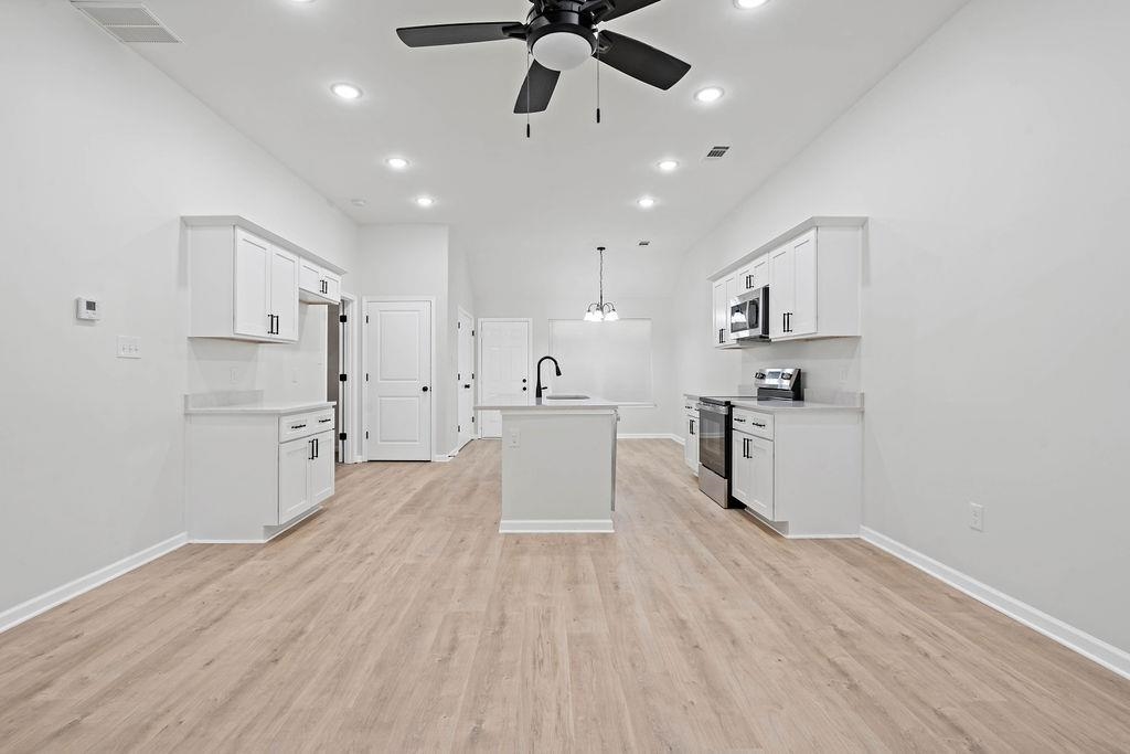351 Edith Avenue Memphis, TN 38126 - Photo 8 of 15 Kitchen featuring stainless steel appliances, white cabinets, recessed lighting, light wood-style flooring, and pendant lighting