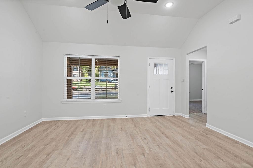 351 Edith Avenue Memphis, TN 38126 - Photo 10 of 15 Unfurnished living room featuring lofted ceiling, light wood-style flooring, and a ceiling fan