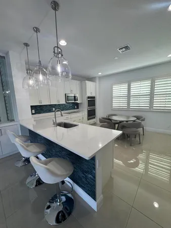 a large kitchen with a table and chairs