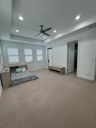 a living room with furniture and a ceiling fan