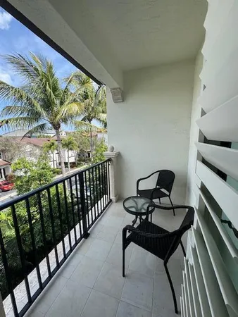 a view of a two chairs in the balcony