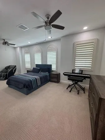 a living room with furniture and a air conditioner vent
