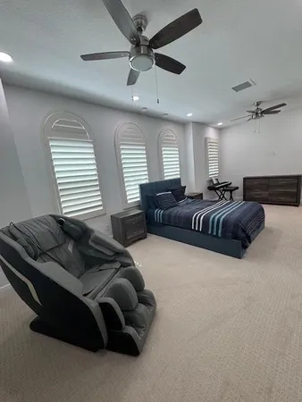 a bedroom with bed couch and window