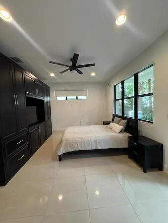 a bedroom with a bed and a television