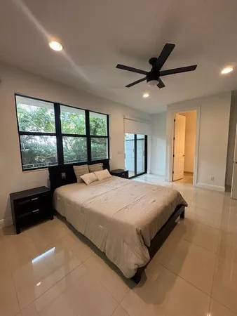 a bedroom with a large bed and a large window