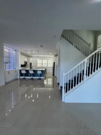 a view of a living room and a kitchen with furniture