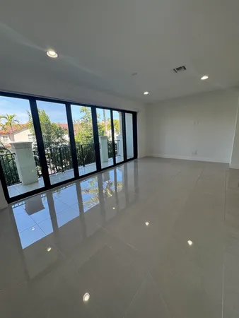 an empty room with large windows