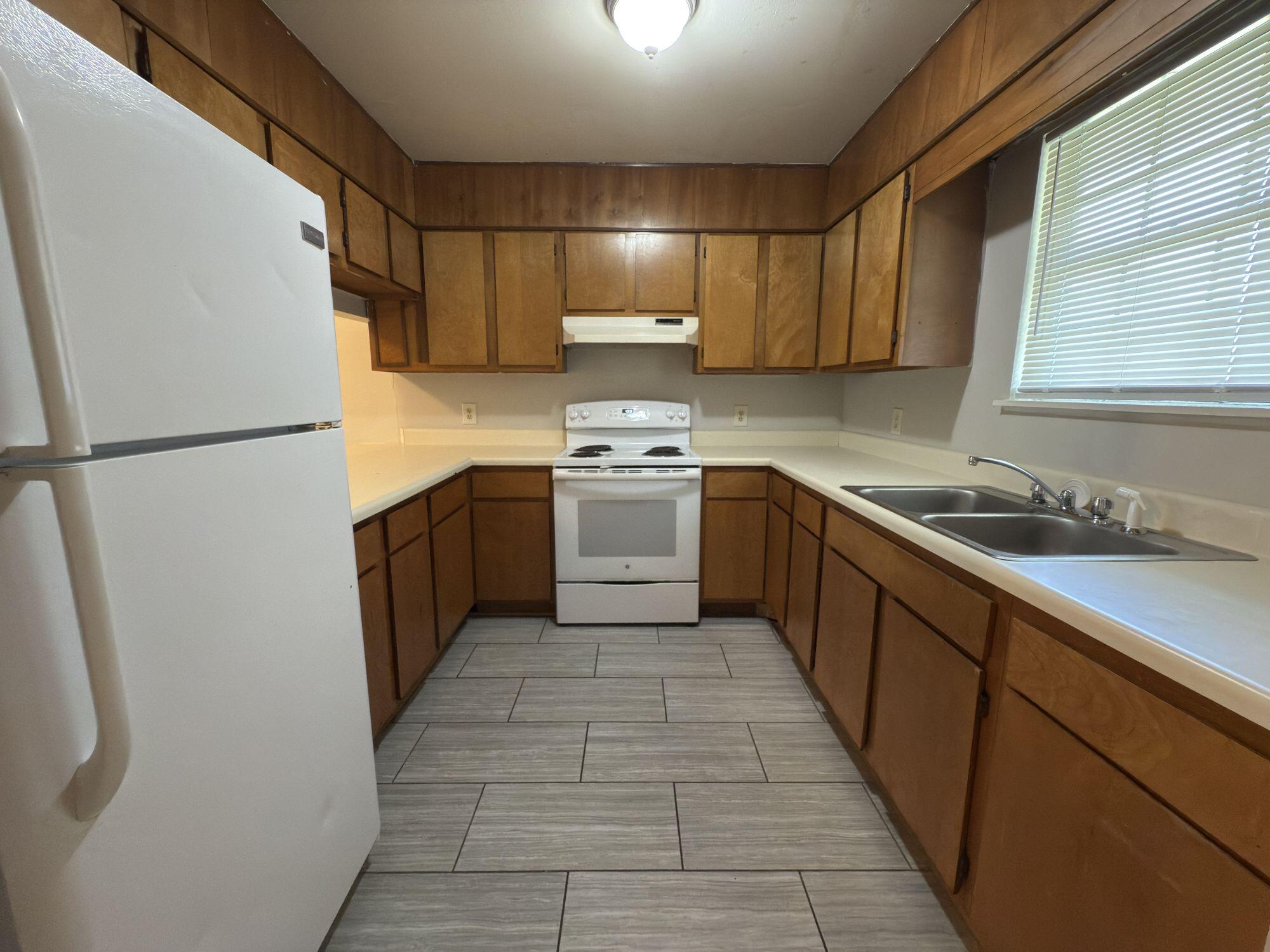 4260 Highway 90, Unit 43 Pace, FL 32571 - Photo 3 of 6 a kitchen with stainless steel appliances granite countertop a refrigerator a sink a stove a washer dryer and a refrigerator