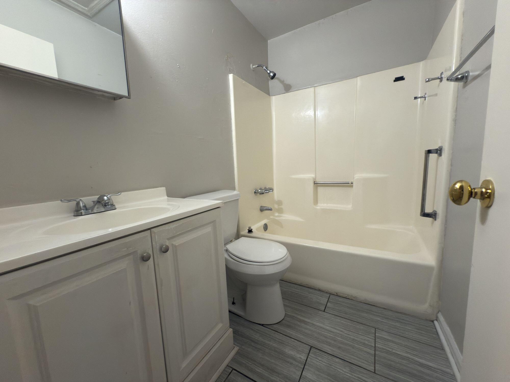 4260 Highway 90, Unit 43 Pace, FL 32571 - Photo 5 of 6 a bathroom with a sink a toilet and shower